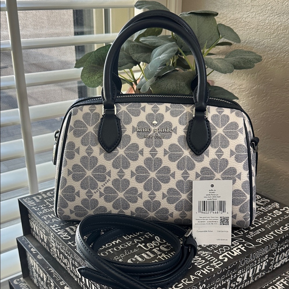 Kate Spade Duffle crossbody in the navy blue spade flower print.